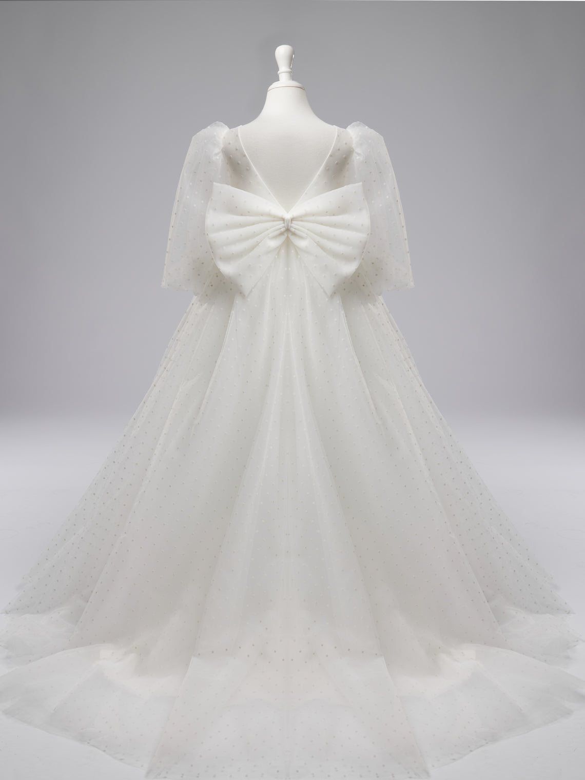 Elegante vestido de niña de las flores para la Primera Comunión, de tul con lunares, mangas abullonadas y cola corta. 