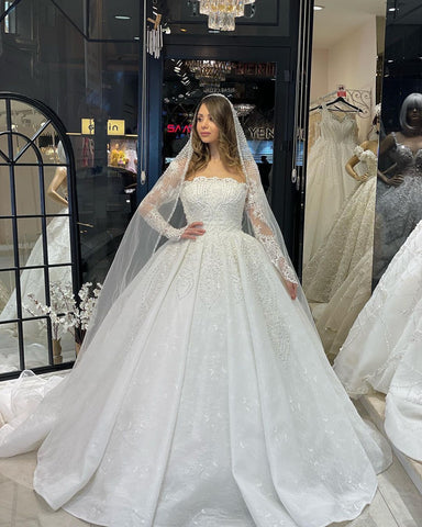 Vestido de novia de encaje de corte A, largo hasta el suelo, de lujo, con mangas largas y volantes.
