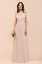 Robe de mariée rose poudré sans manches, coupe trapèze, idéale pour une invitée ou une demoiselle d'honneur de plage