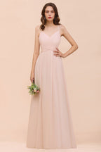 Robe de mariée rose poudré sans manches, coupe trapèze, idéale pour une invitée ou une demoiselle d'honneur de plage