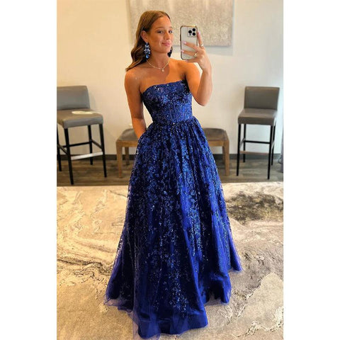 Vestido largo de fiesta de corte A, sin tirantes, con apliques de lentejuelas y bolsillos.