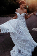 Robe de mariée élégante en tulle blanc, coupe trapèze, épaules dénudées, ornée d'appliqués WD337