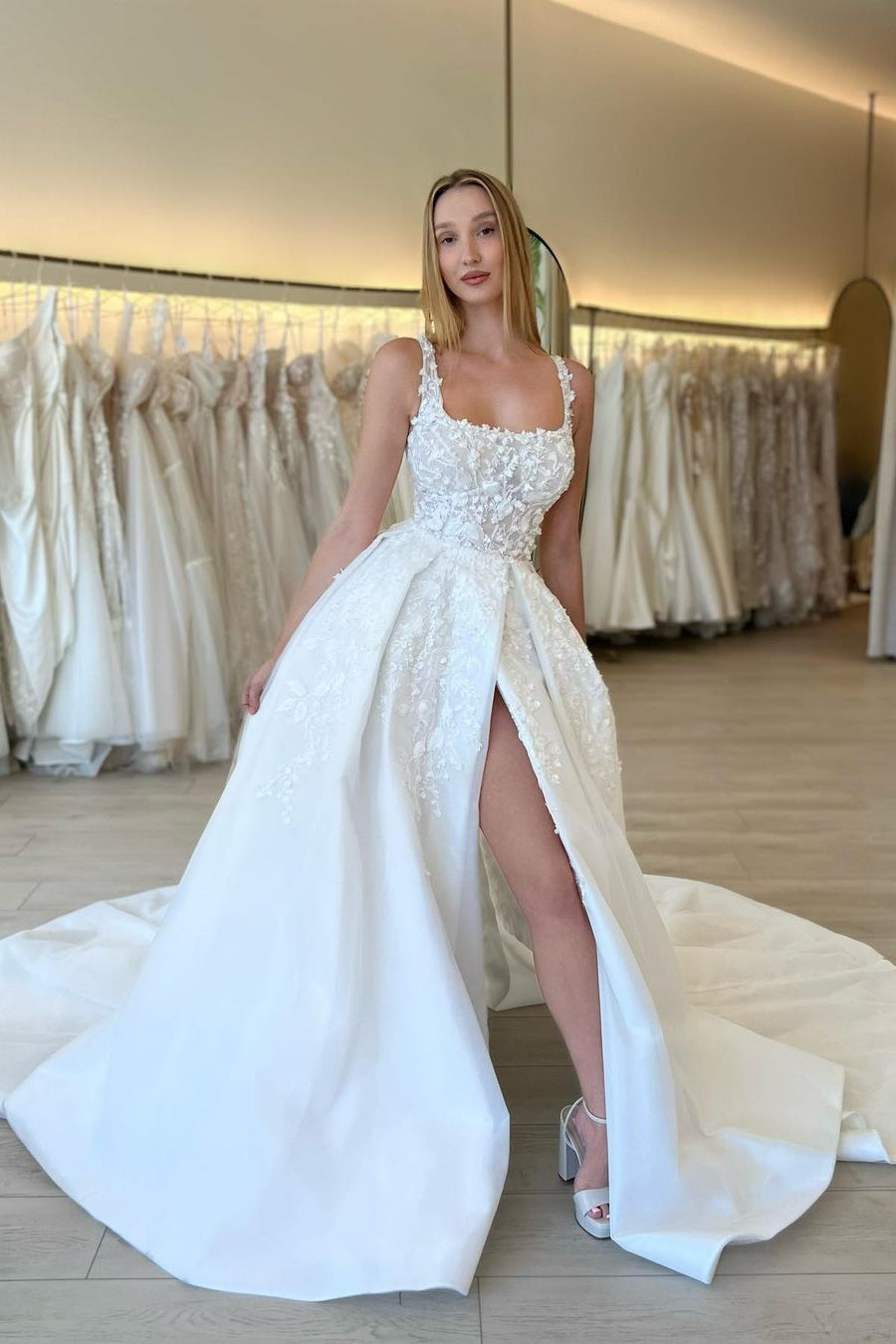 Elegante vestido de novia de encaje sin mangas con tirantes, flores y corte en A, con abertura.