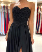Elegante vestido de fiesta largo negro de corte A, escote corazón, de gasa y abertura.