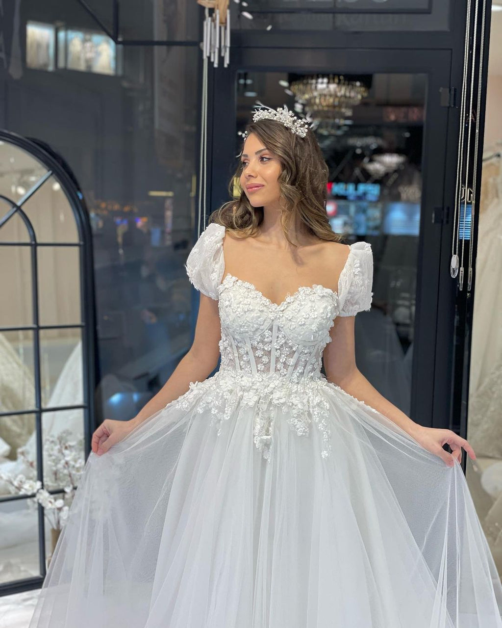 Robe de mariée élégante en tulle, longue jusqu'au sol, décolleté cœur, manches courtes et coupe trapèze, ornée d'une encolure en cœur.
