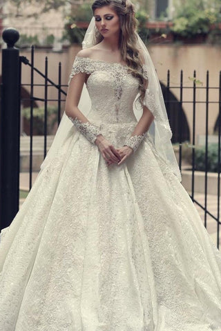 Elegante vestido de novia largo de corte A, con hombros descubiertos, espalda descubierta, apliques de encaje y mangas.