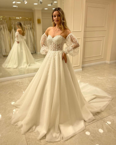 Elegante vestido de novia de manga larga, corte en A, escote corazón, espalda descubierta y apliques de encaje