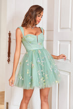 Robe courte vert clair élégante, coupe trapèze, décolleté cœur et broderies.