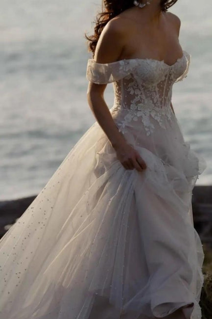 Fabuloso vestido de novia blanco de corte A, sin mangas, con encaje, hombros descubiertos y volantes.