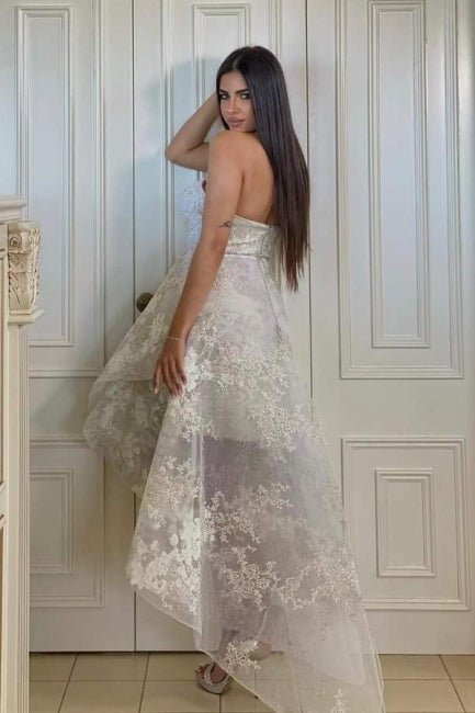 Fabuleuse robe de mariée blanche en dentelle, coupe trapèze, décolleté cœur, sans manches, ornée d'appliques