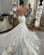 Robe de mariée sirène longue sans manches à décolleté cœur ornée de dentelle, absolument fabuleuse !