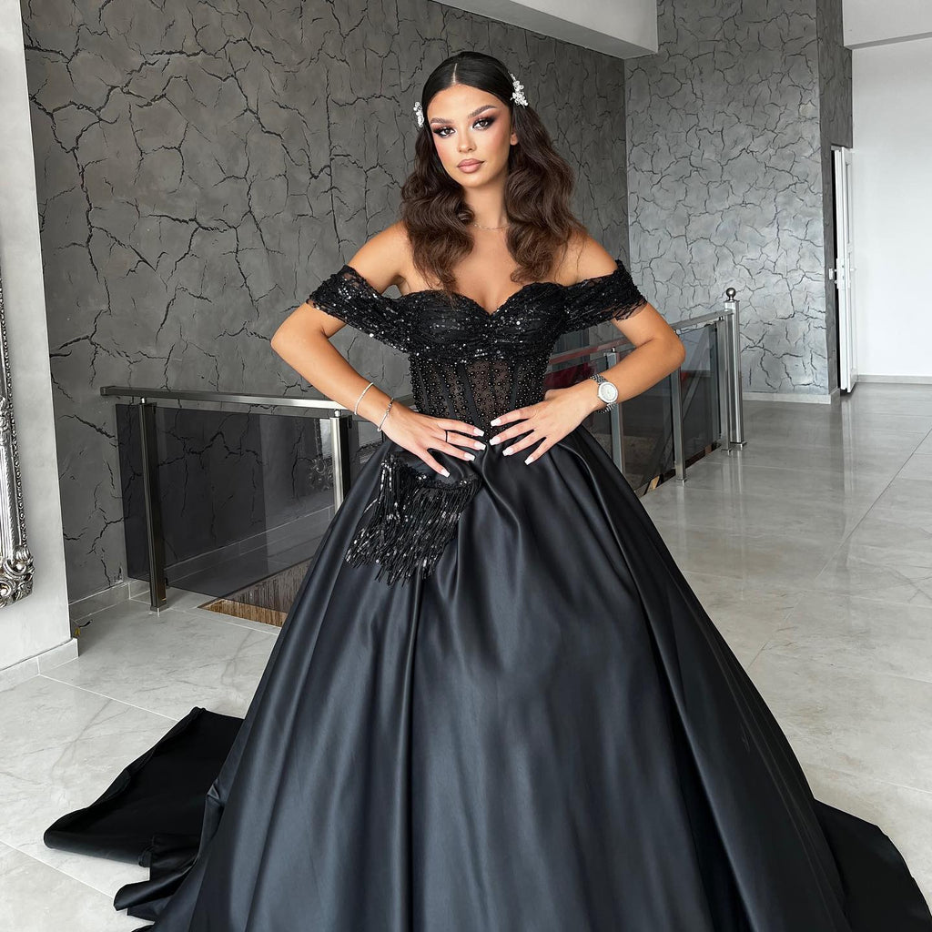 Elegantes vestidos de noche negros de fiesta con escote corazón y hombros descubiertos, adornados con cuentas.