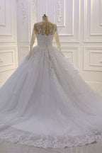 Precioso vestido de novia largo de corte A con escote barco, apliques de tul con perlas y encaje, con mangas.