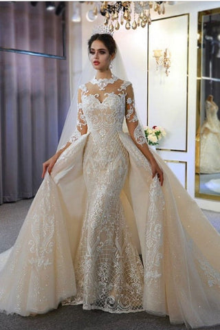 Precioso vestido de novia largo de corte A, escote corazón, apliques de encaje y mangas con mangas.