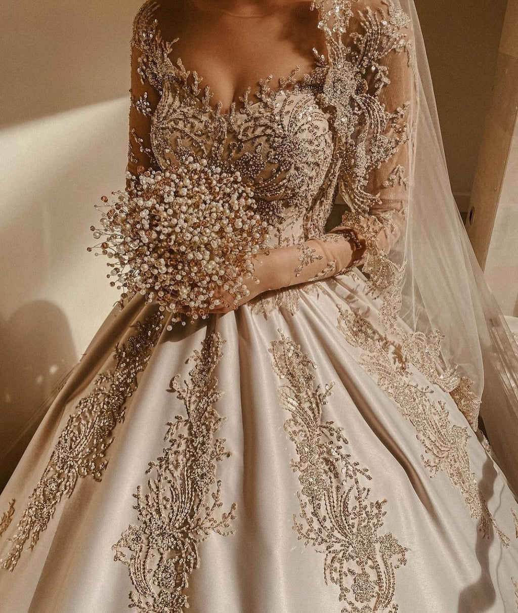 Magnifique robe de mariée longue princesse en satin perlé avec manches et décolleté cœur