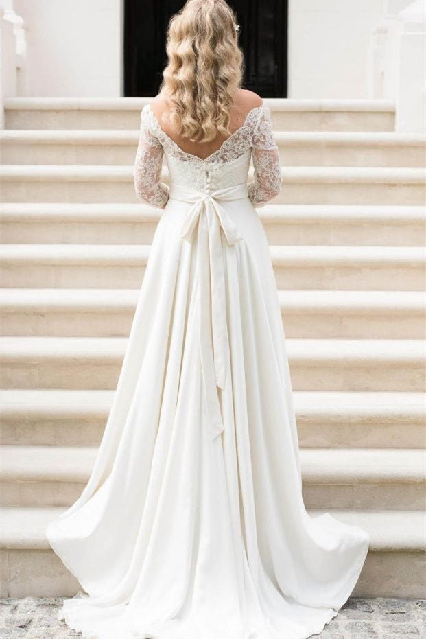 Vestido de novia bohemio de encaje con manga corta, hombros descubiertos y espalda en V.