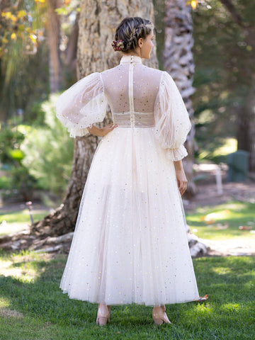 Robe de bal fendue sur le devant, col montant et poignets à volants