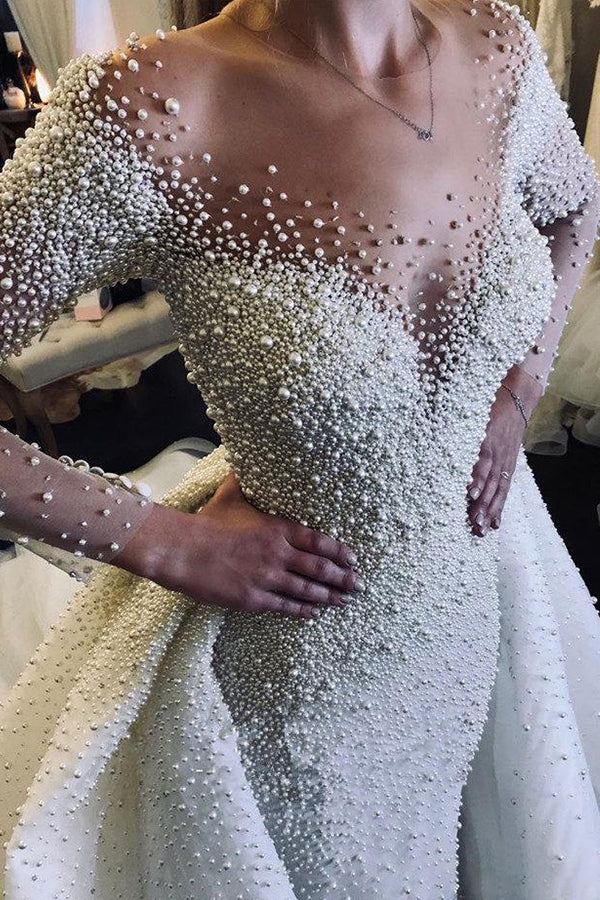 Robe de mariée ivoire à manches longues, traîne amovible, col en V, boutons et entièrement recouverte de perles 