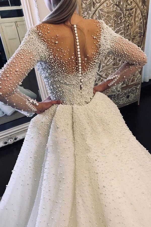 Robe de mariée ivoire à manches longues, traîne amovible, col en V, boutons et entièrement recouverte de perles 