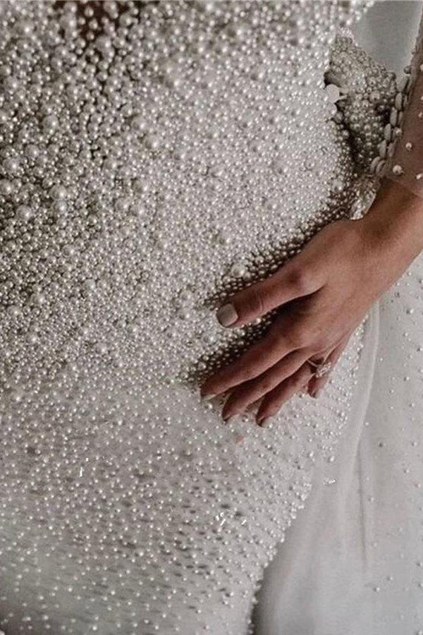 Robe de mariée ivoire à manches longues, traîne amovible, col en V, boutons et entièrement recouverte de perles 