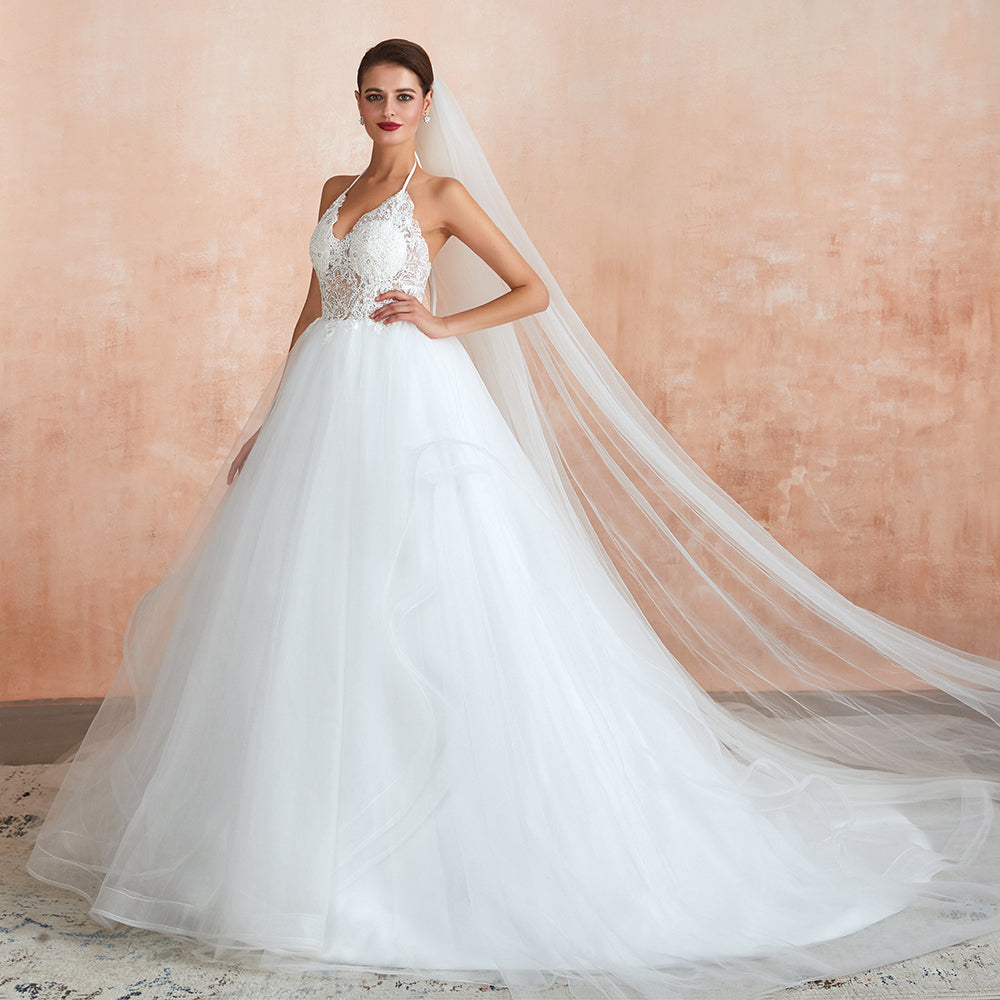 Vestido de novia largo de corte A con escote halter, espalda descubierta y apliques de tul