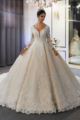 Vestido de novia largo de corte A, escote corazón, espalda descubierta, apliques de encaje y lentejuelas, con mangas.