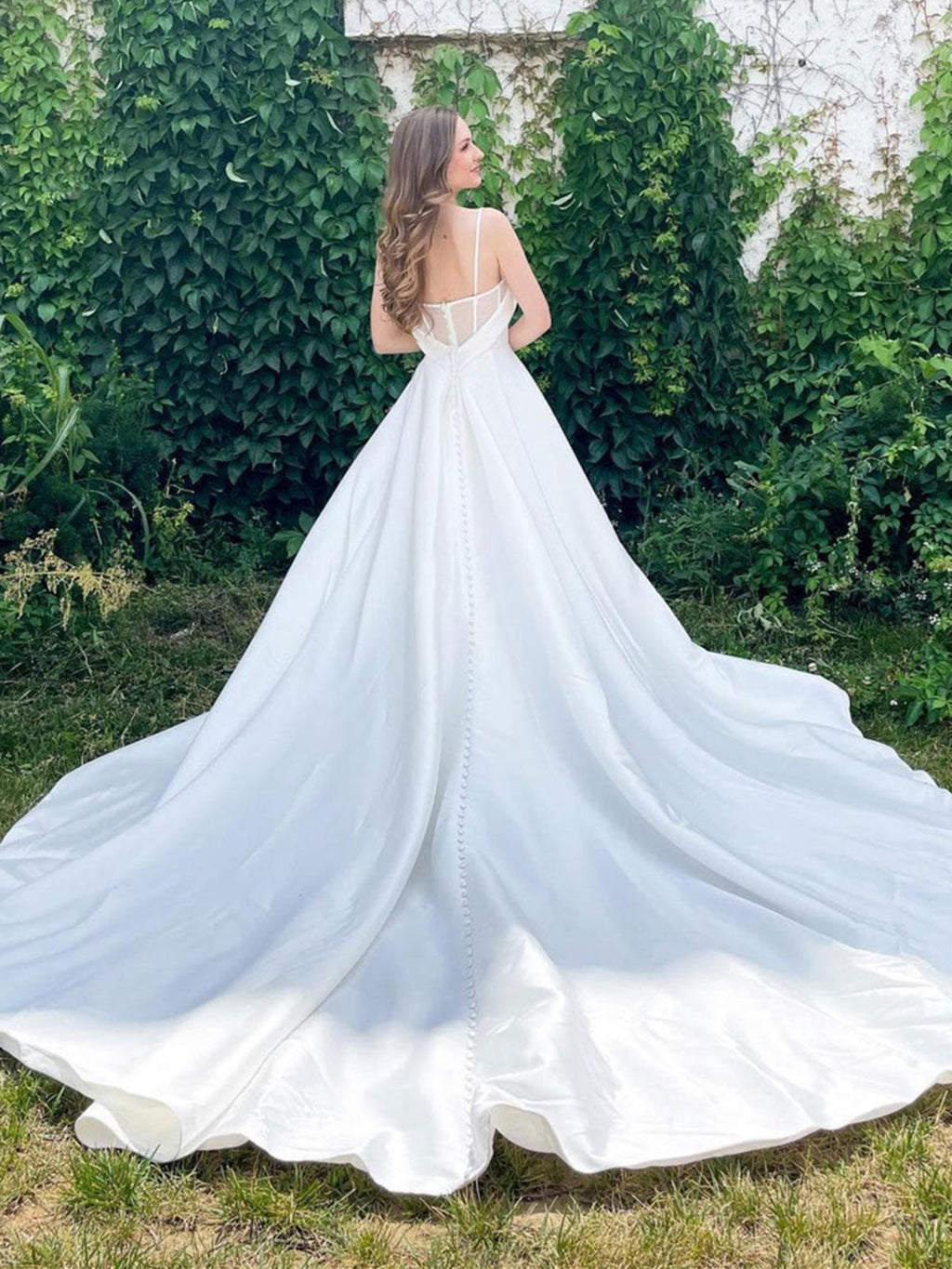 Robe de mariée longue en satin, coupe trapèze, décolleté cœur, dos nu et poches