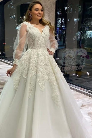 Vestido de novia largo de corte A, escote en V, apliques de encaje y tul con mangas largas abullonadas.