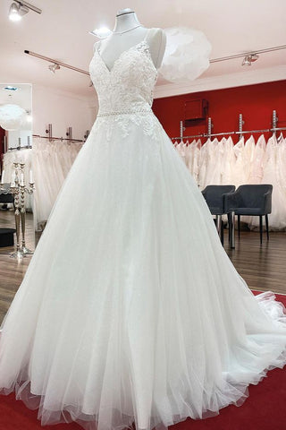 Vestido de novia largo de corte A, escote en V, tirantes finos, espalda descubierta y encaje.