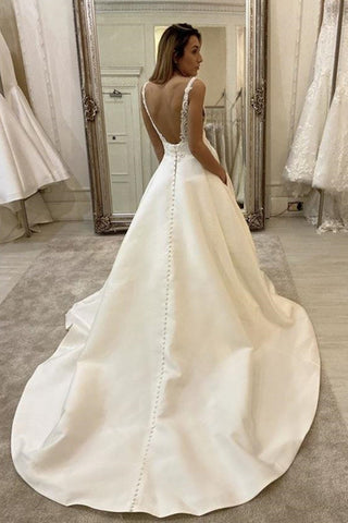 Vestido de novia largo de corte A, escote en V, tirantes finos, espalda descubierta y con bolsillos.