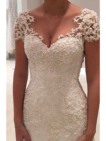 Vestidos de novia largos de sirena con escote en V, tul, encaje y espalda descubierta con mangas cortas.