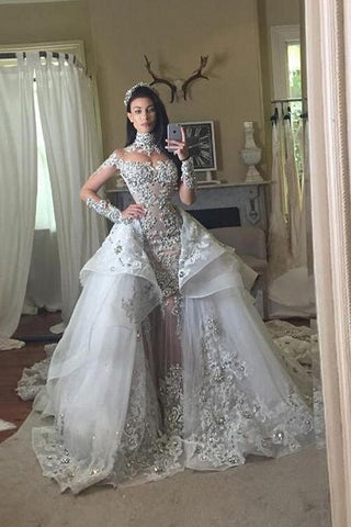 Vestidos de novia de tul de manga larga, cuello alto, apliques de encaje y sobrefalda desmontable.