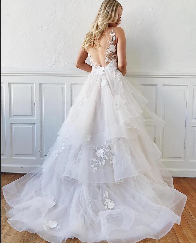Robe de mariée sobre, longue, trapèze, col en V, bretelles spaghetti, dos nu en tulle, à col en V.