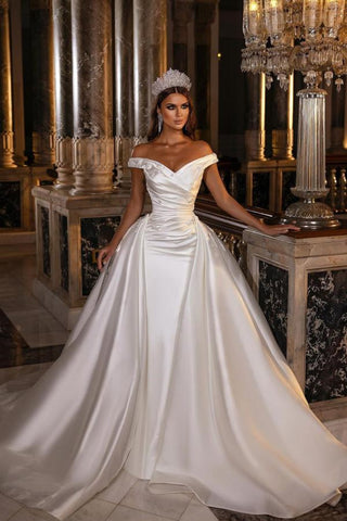 Robe de mariée en satin à épaules dénudées, sobre et élégante, avec traîne amovible. 