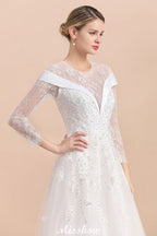 Vestido de novia sencillo con apliques de cuentas blancas, manga larga y largo hasta el suelo.
