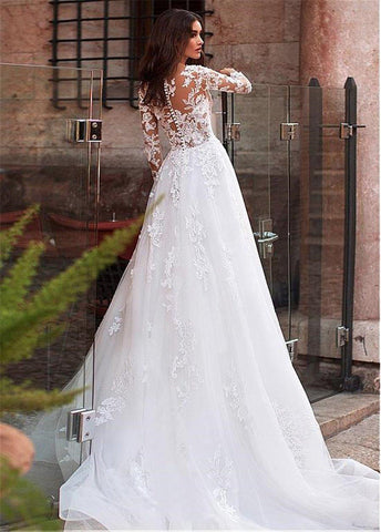Vestido de novia de corte A, corte sirena, con escote joya de tul, corpiño transparente, apliques de encaje y pedrería, mangas largas.
