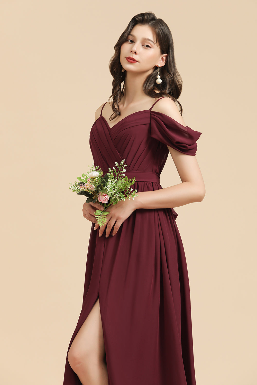 Vestido largo de dama de honor color burdeos con escote corazón y hombros descubiertos, con abertura. 