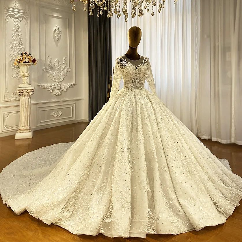 Robe de mariée princesse élégante en dentelle, coupe trapèze, manches longues et traîne