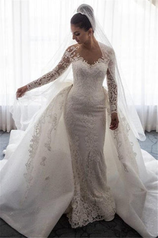 Impresionante vestido de novia estilo sirena con encaje, lazo y sobrefalda desmontable.