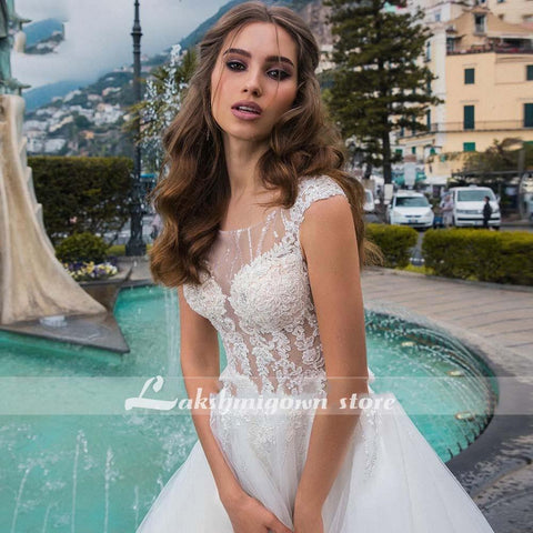 Baoleely White Wedding Dresses Appliques Sequined Cap Sleeve